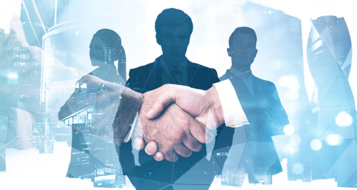 Close,Up,Of,Two,Businessmen,Shaking,Hands,In,Abstract,Blurry